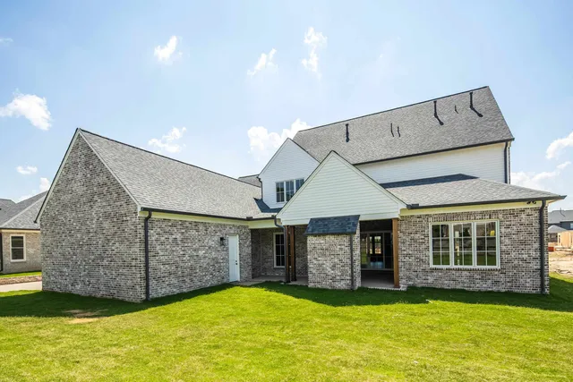 a view of an empty room with a fireplace and a window