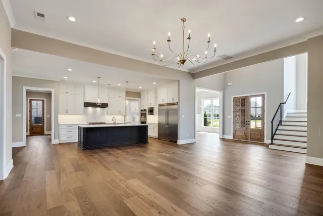 a view of a livingroom with furniture and kitchen floor