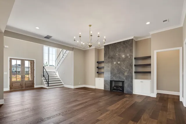 a large white kitchen with a large window and stainless steel appliances