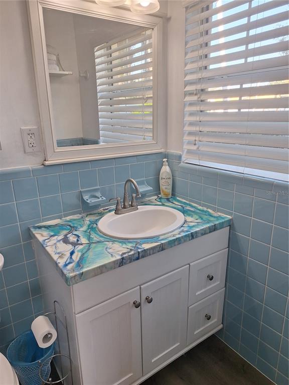 1202 South Keene Road Clearwater, FL 33756 - Photo 11 of 46 a bathroom with a granite countertop sink a toilet and a mirror