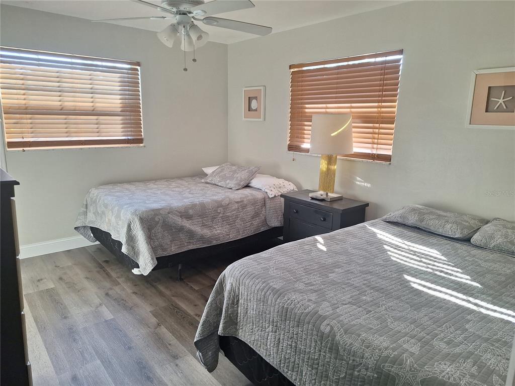 1202 South Keene Road Clearwater, FL 33756 - Photo 16 of 46 a bedroom with two beds and a window