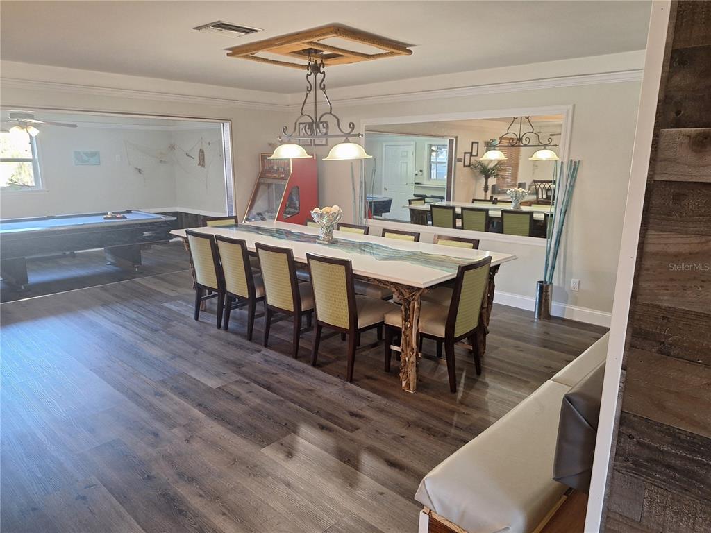 1202 South Keene Road Clearwater, FL 33756 - Photo 17 of 46 a view of a dining room with furniture wooden floor and chandelier