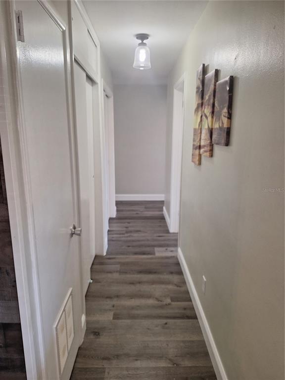 1202 South Keene Road Clearwater, FL 33756 - Photo 19 of 46 a view of a hallway with wooden floor
