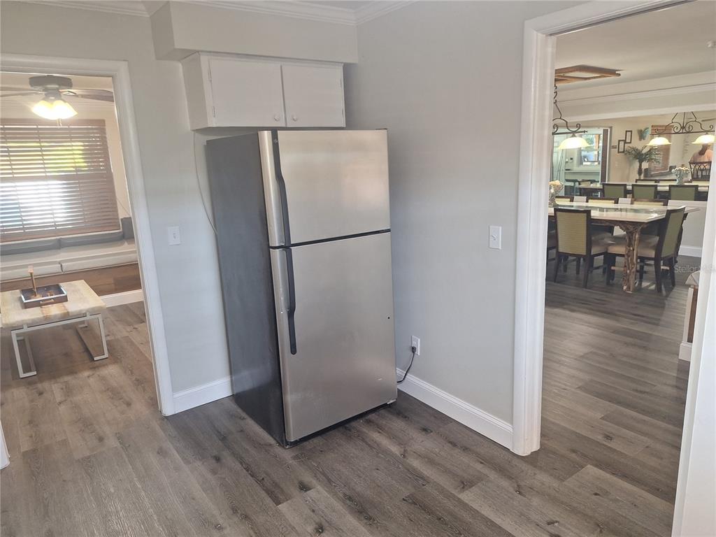 1202 South Keene Road Clearwater, FL 33756 - Photo 21 of 46 a view of a kitchen with wooden floor and a refrigerator