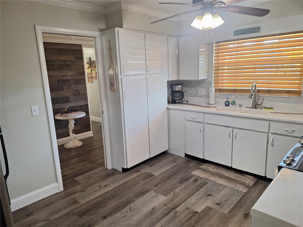 1202 South Keene Road Clearwater, FL 33756 - Photo 22 of 46 a kitchen with stainless steel appliances a sink cabinets and wooden floor