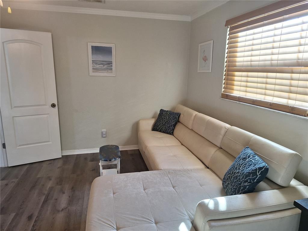 1202 South Keene Road Clearwater, FL 33756 - Photo 26 of 46 a bed room with a bed and a couch