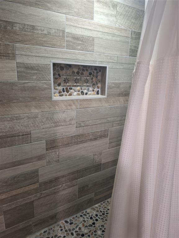 1202 South Keene Road Clearwater, FL 33756 - Photo 28 of 46 a bathroom with a shower