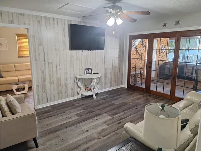 a reading room with wooden floor and furniture