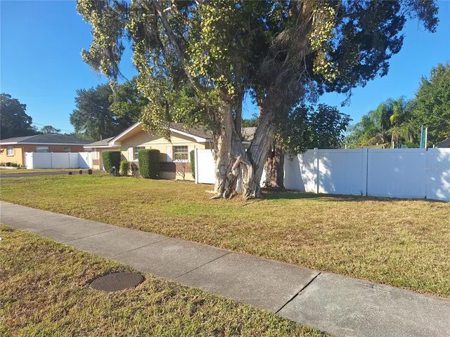 a house view with swimming pool in front of it