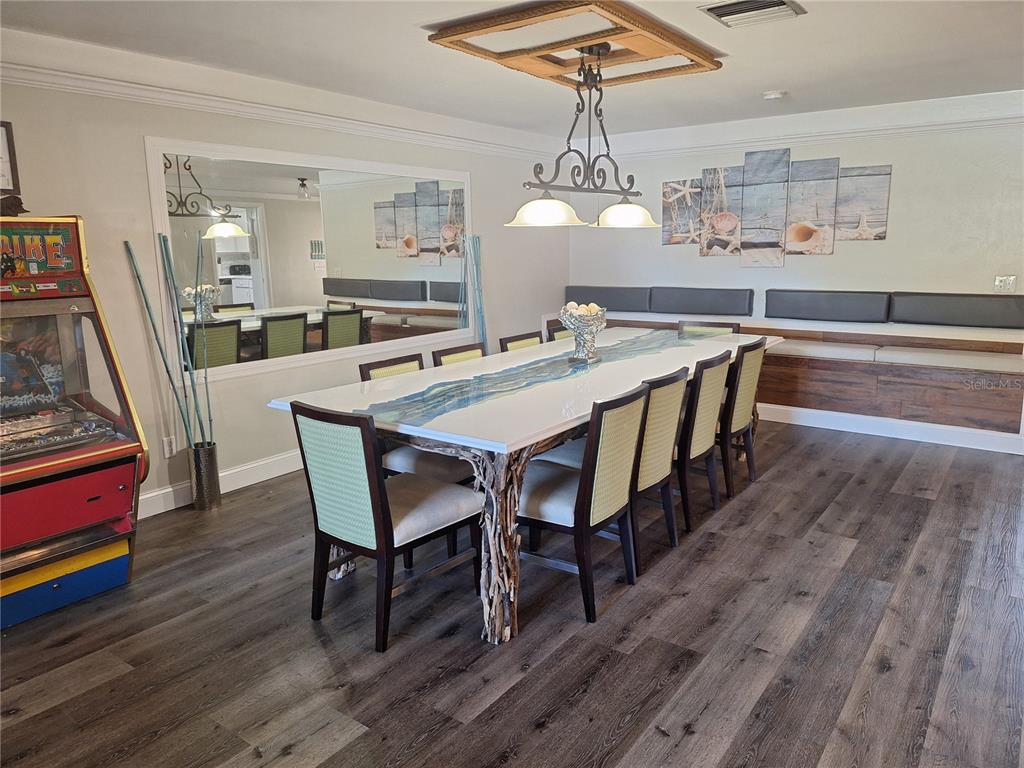 1202 South Keene Road Clearwater, FL 33756 - Photo 34 of 46 a view of a dining room with furniture wooden floor and chandelier
