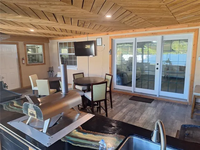 a view of a patio with a table chairs and a yard