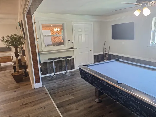 a room with pool table and a flat screen tv