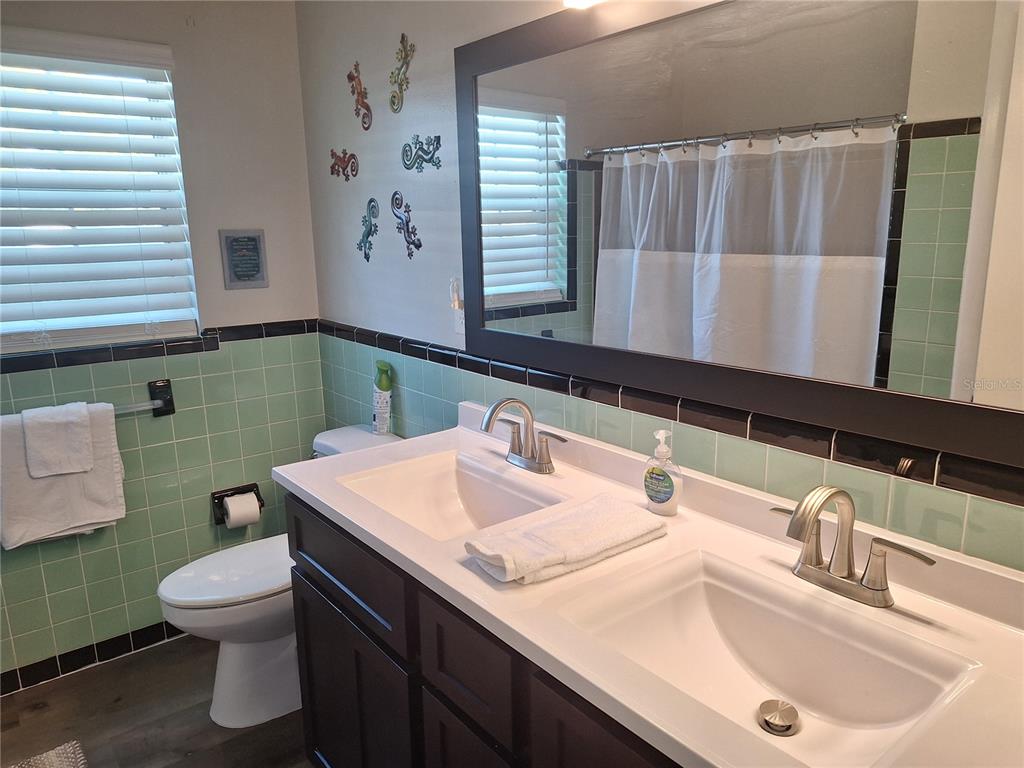 1202 South Keene Road Clearwater, FL 33756 - Photo 8 of 46 a bathroom with a sink and a mirror