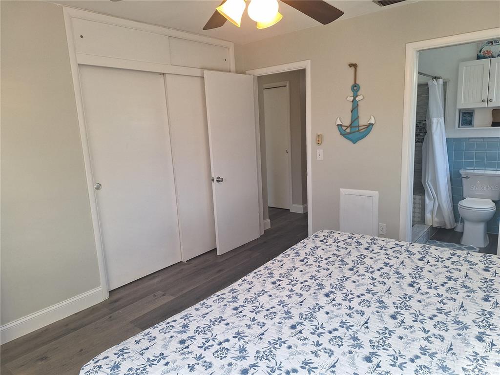 1202 South Keene Road Clearwater, FL 33756 - Photo 9 of 46 a bedroom with a bed and a chandelier