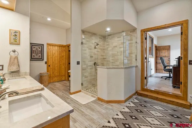 a spacious bedroom with a bed and a flat screen tv