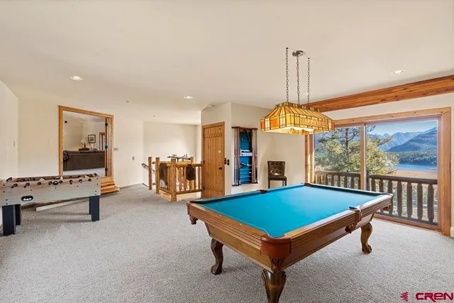 a living room with furniture and floor to ceiling windows