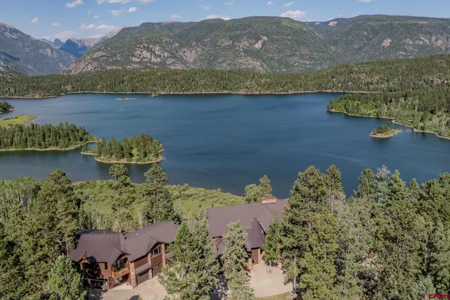 an aerial view of a house with a lake view
