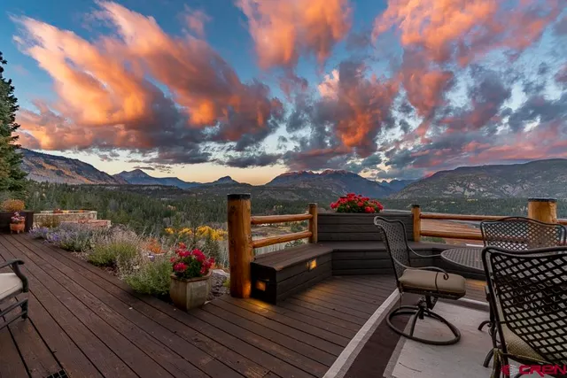 a view of a lush green hillside and a building