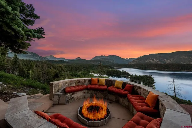 a view of a house with a yard and sitting area