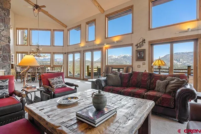 a view of a patio with a table and chairs and floor to ceiling window