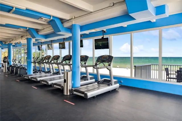 a bedroom with furniture and large windows
