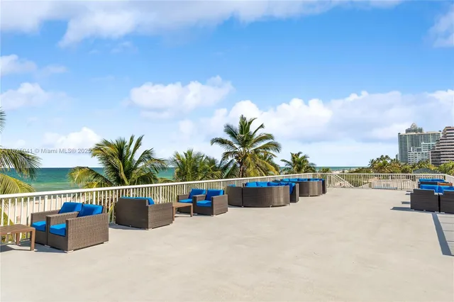 a view of roof deck with a barbeque and wooden stairs