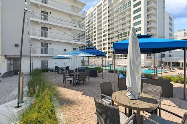a view of a building with a dining table and chairs