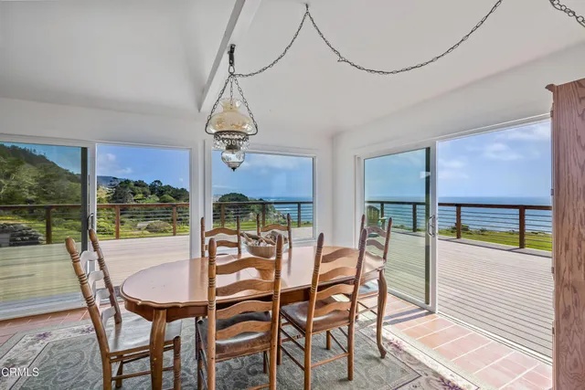 a view of a dining room with furniture window and outside view