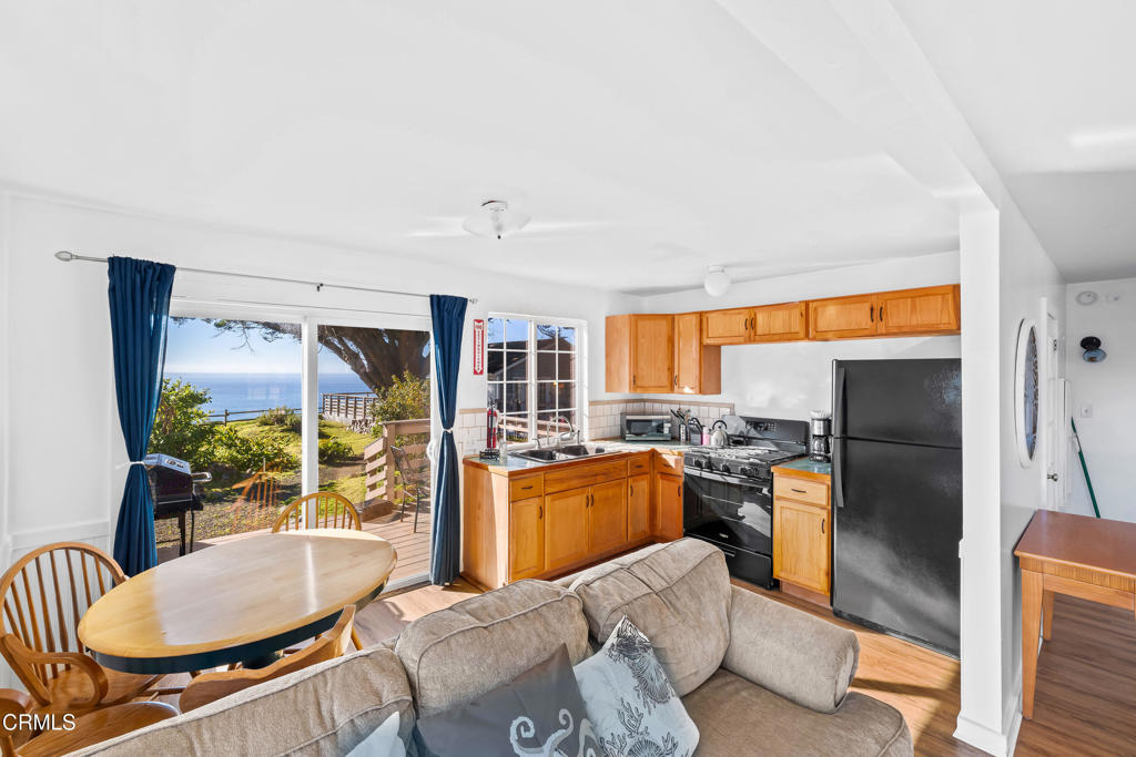 1990 Highway 1 Albion, CA 95410 - Photo 42 of 57 a living room with furniture a large window and stainless steel appliances