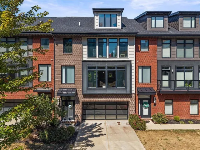 a front view of a building with a garden