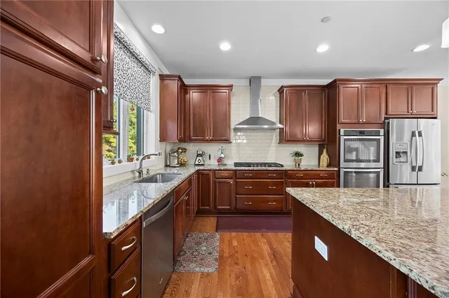 a large kitchen with granite countertop lots of counter top space and sink