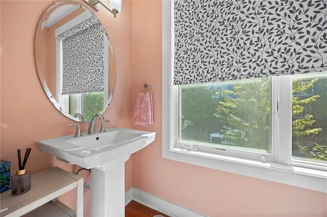 a bathroom with a sink a mirror and a window