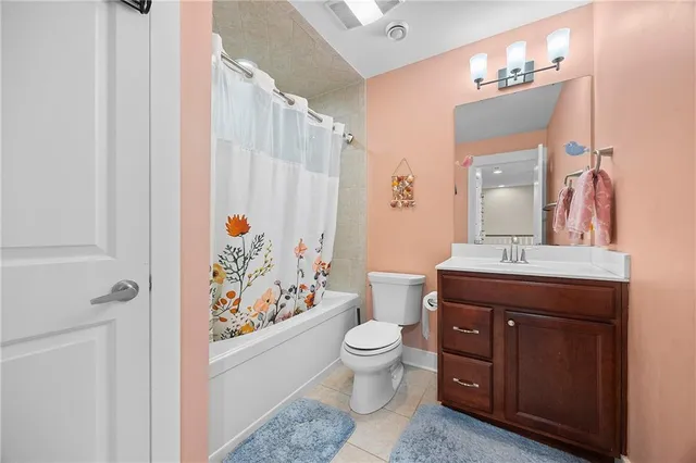 a spacious bathroom with a double vanity sink toilet and shower
