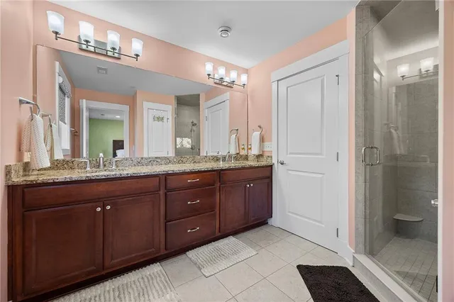a spacious bathroom with a granite countertop sink mirror and shower