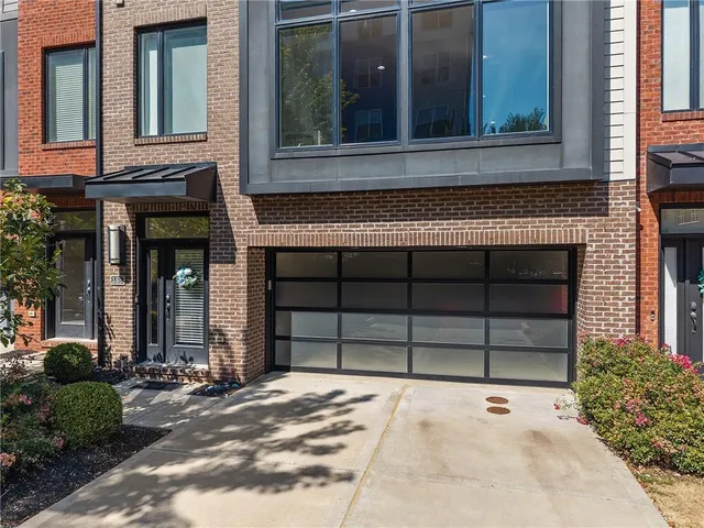 front view of a house with a yard and garage