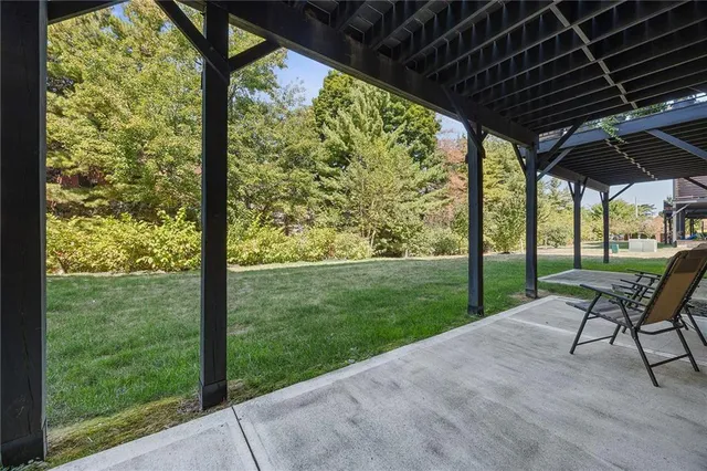 a view of porch with a table chairs and a yard