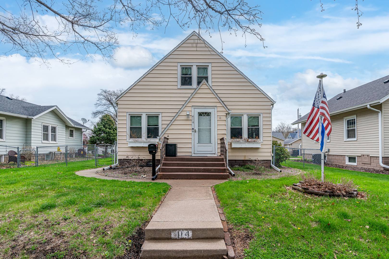 414 45th Street Moline, IL 61265 - Photo 1 of 13 a front view of a house with a yard