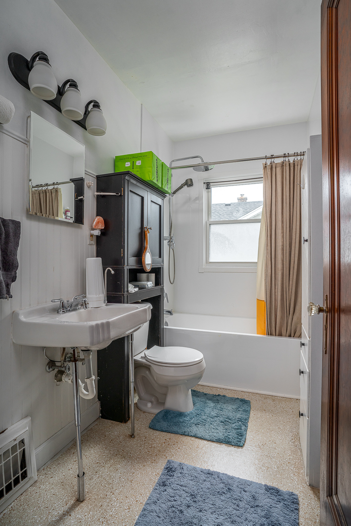 414 45th Street Moline, IL 61265 - Photo 10 of 13 a bathroom with a sink a toilet and tub