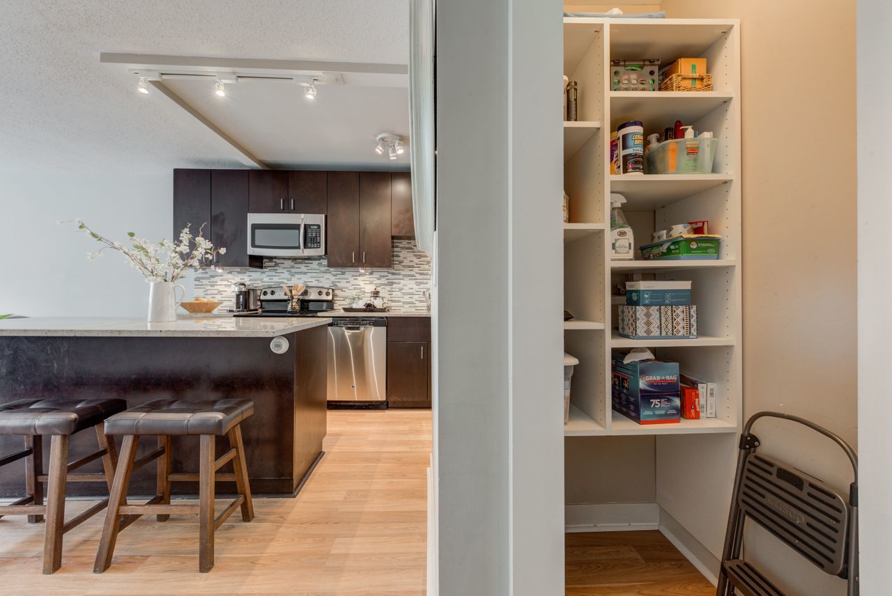 2930 North Sheridan Road, Unit 1010 Chicago, IL 60657 - Photo 13 of 24 a living room with stainless steel appliances furniture a rug and a kitchen view