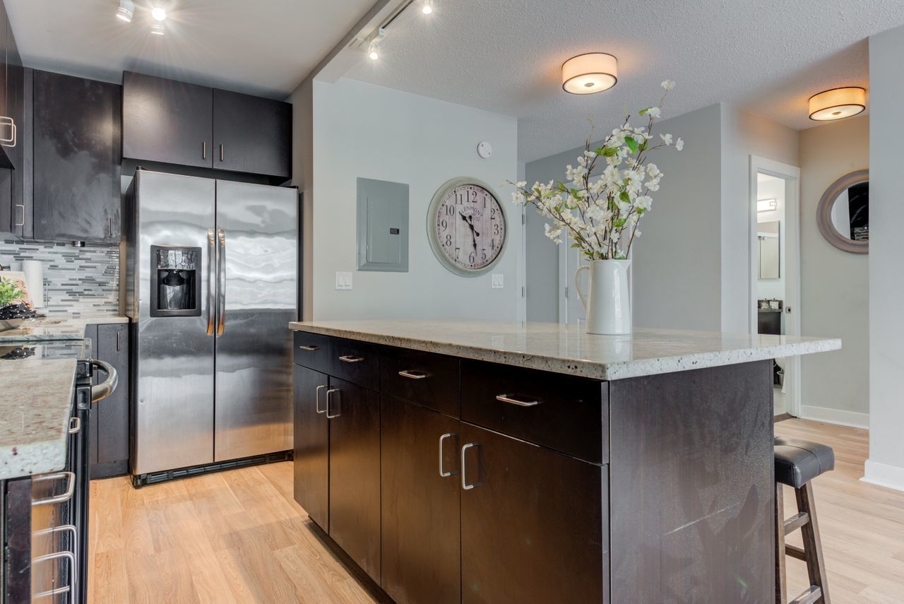 2930 North Sheridan Road, Unit 1010 Chicago, IL 60657 - Photo 5 of 24 a kitchen with stainless steel appliances granite countertop a refrigerator a oven a sink and a refrigerator