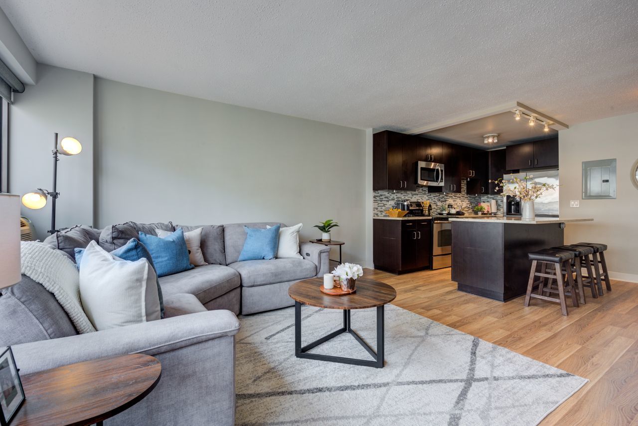 2930 North Sheridan Road, Unit 1010 Chicago, IL 60657 - Photo 8 of 24 a living room with stainless steel appliances kitchen island granite countertop furniture and a wooden floor