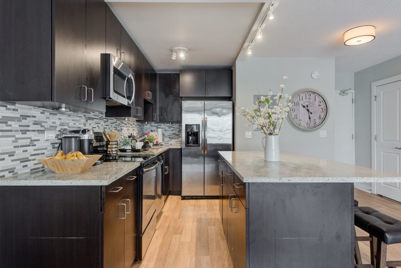 2930 North Sheridan Road, Unit 1010 Chicago, IL 60657 - Photo 9 of 24 a kitchen with stainless steel appliances granite countertop a sink stove and refrigerator