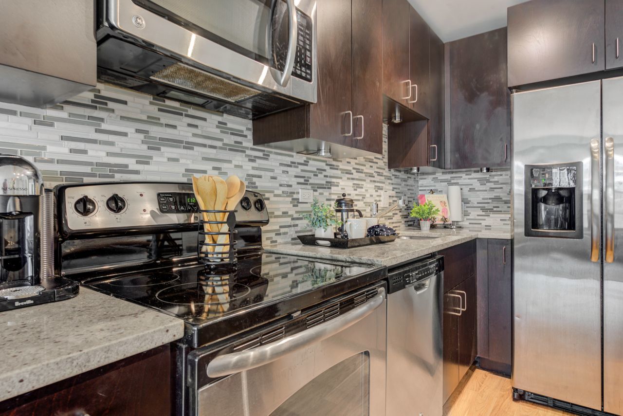 2930 North Sheridan Road, Unit 1010 Chicago, IL 60657 - Photo 10 of 24 a kitchen with a stove and a sink