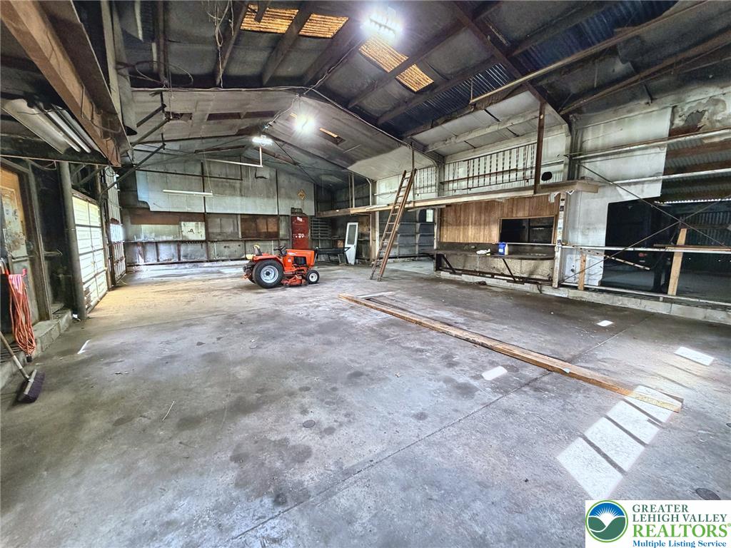 4995 Mountain Road Slatington, PA 18080 - Photo 24 of 30 A spacious workshop with high ceilings and a concrete floor, ready for any project.
