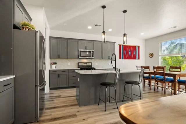 a large kitchen with a table and chairs