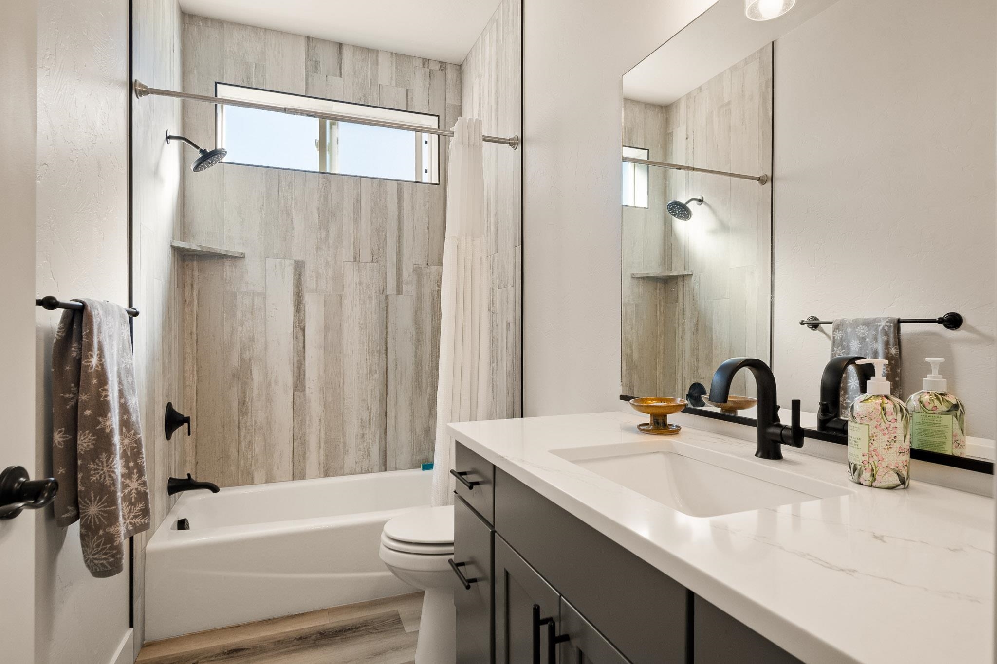 559 Hobbs Court Fruita, CO 81521 - Photo 20 of 40 a bathroom with a sink a toilet and a mirror