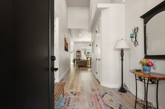 a view of a hallway view with wooden floor and furniture