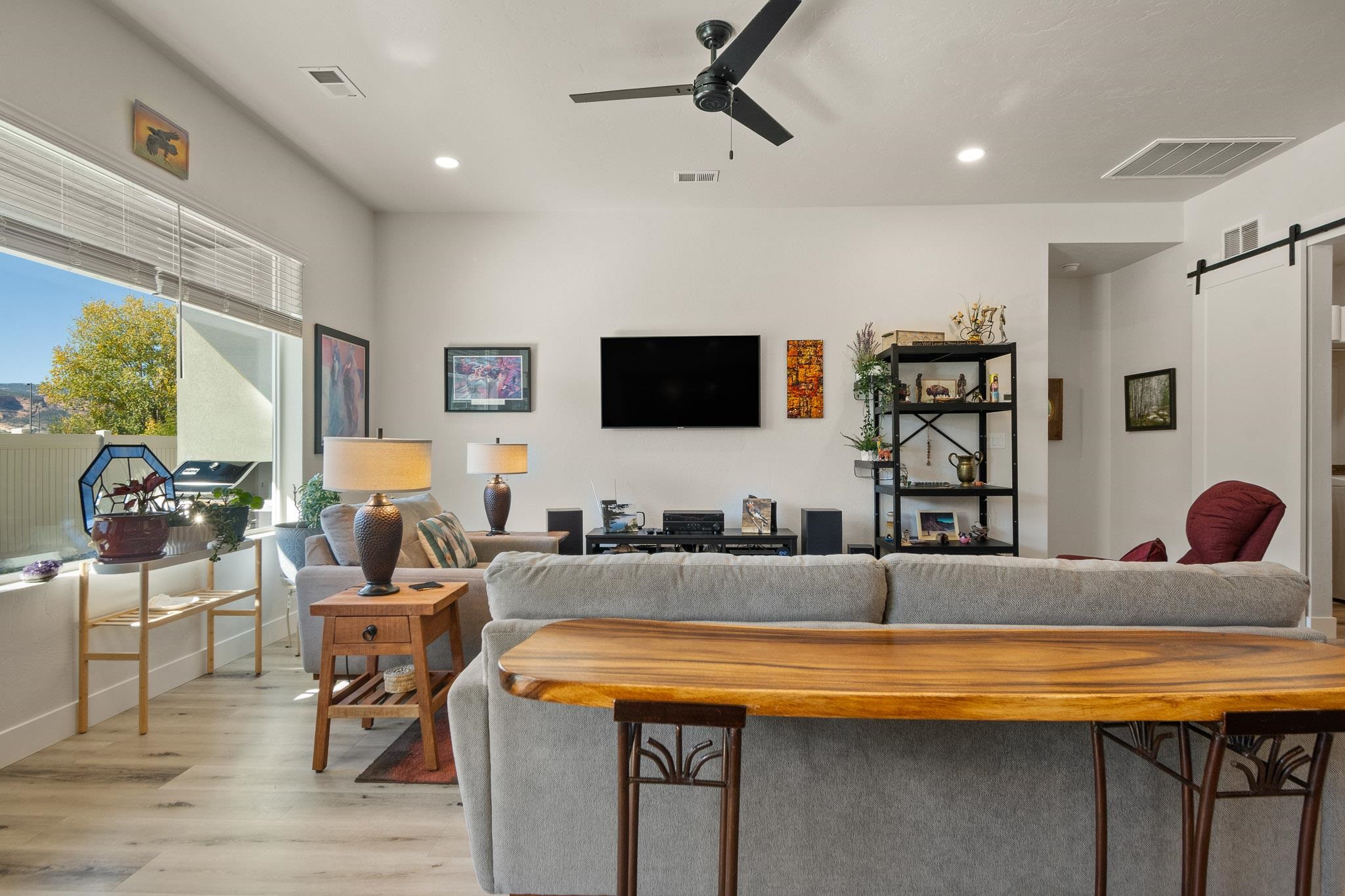559 Hobbs Court Fruita, CO 81521 - Photo 8 of 40 a living room with stainless steel appliances kitchen island granite countertop furniture and a flat screen tv