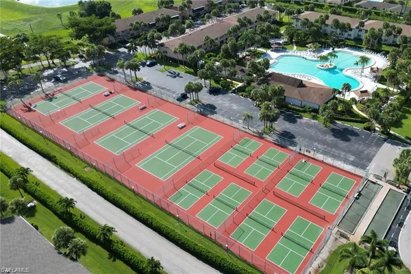 a aerial view of a tennis ground that has a lot of plants and flowers