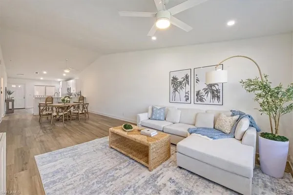a living room with furniture and a large mirror
